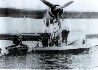 The boat which towed the Sea Otter. In the boat left to right Bert Bosbury, the pilot, and Bill Burbage